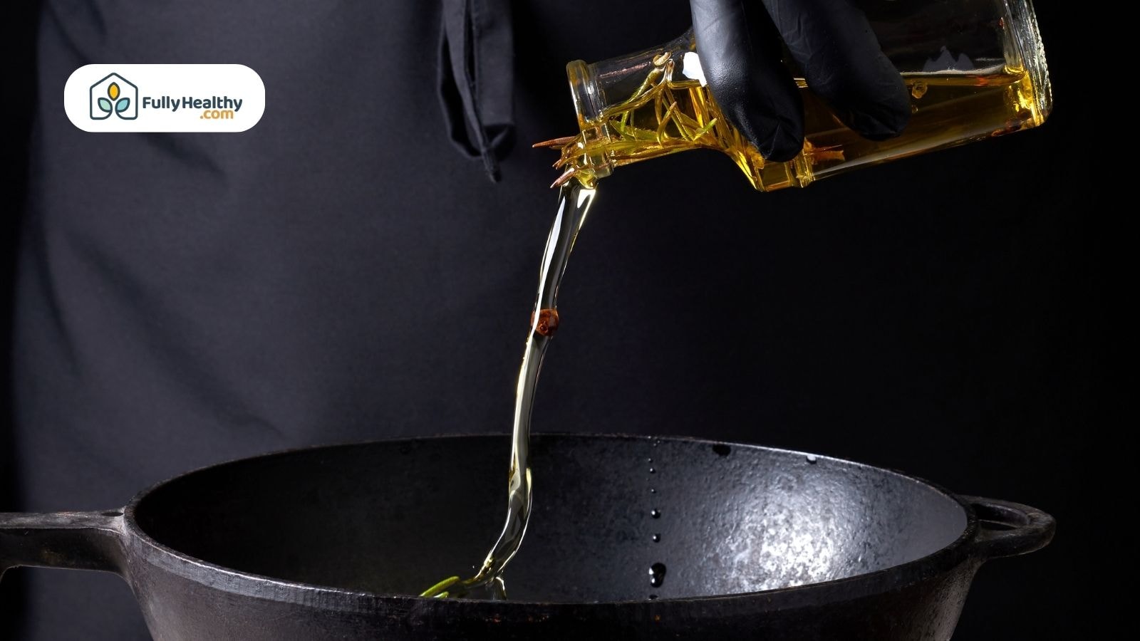 Hand pouring extra virgin olive oil into a hot cast iron pan