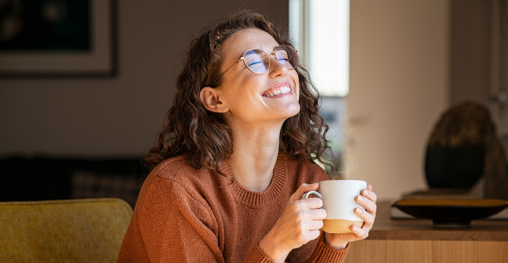 happy woman enjoying coffee at home