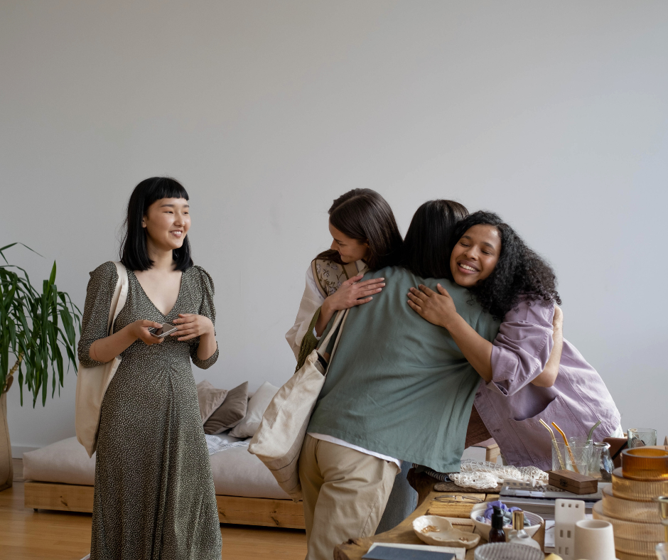 women embrace at a class