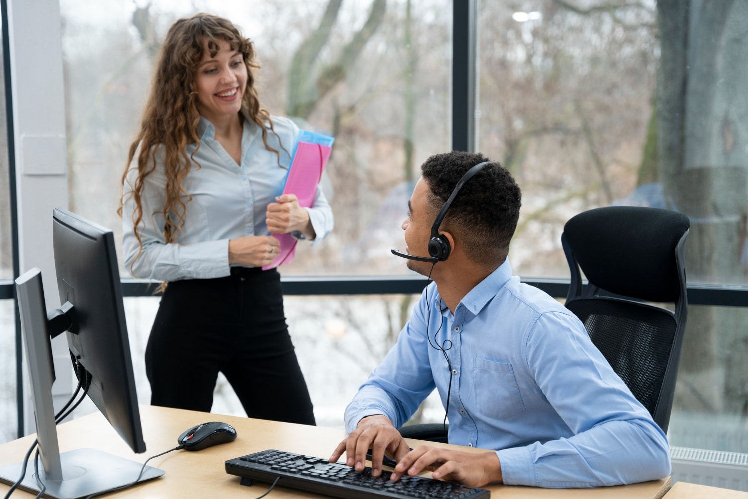 Customer service team collaborates using streamlined phone solutions; a headset-wearing agent engages in affordable business communication with easy-to-use phone systems.