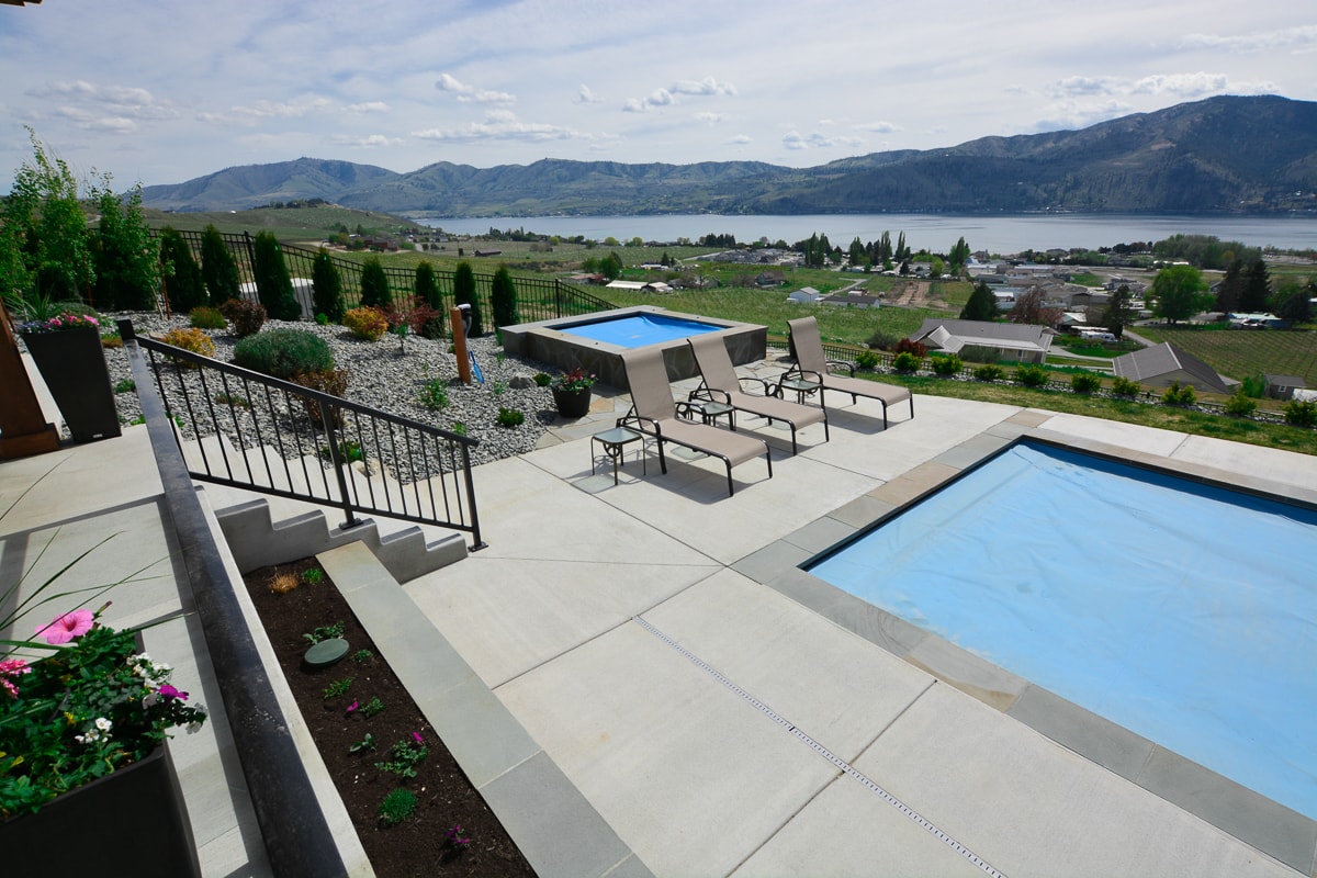 Beautiful swimming pools area with fire pit in the distance