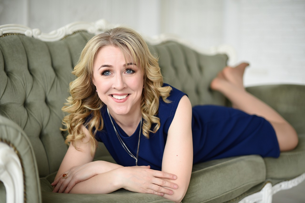 An image of a young woman relaxing on couch at home due to her humidifier.