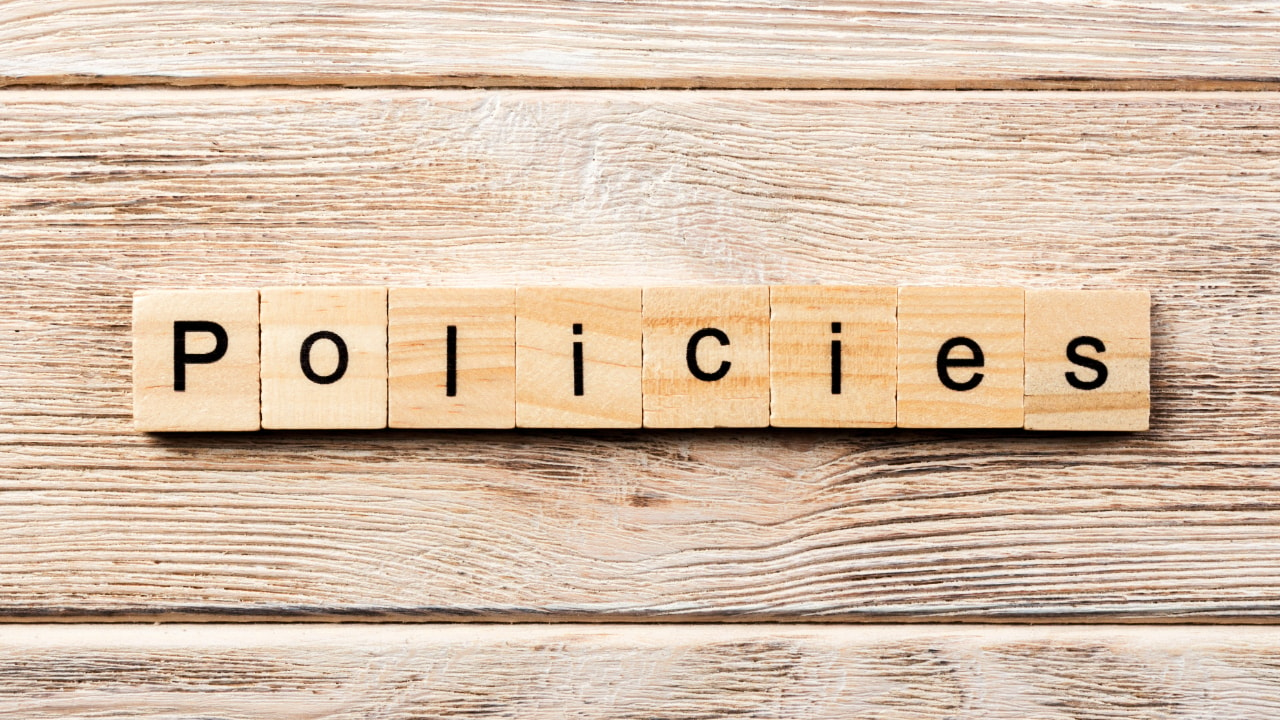 policies scrabble pieces, wooden tabletop 