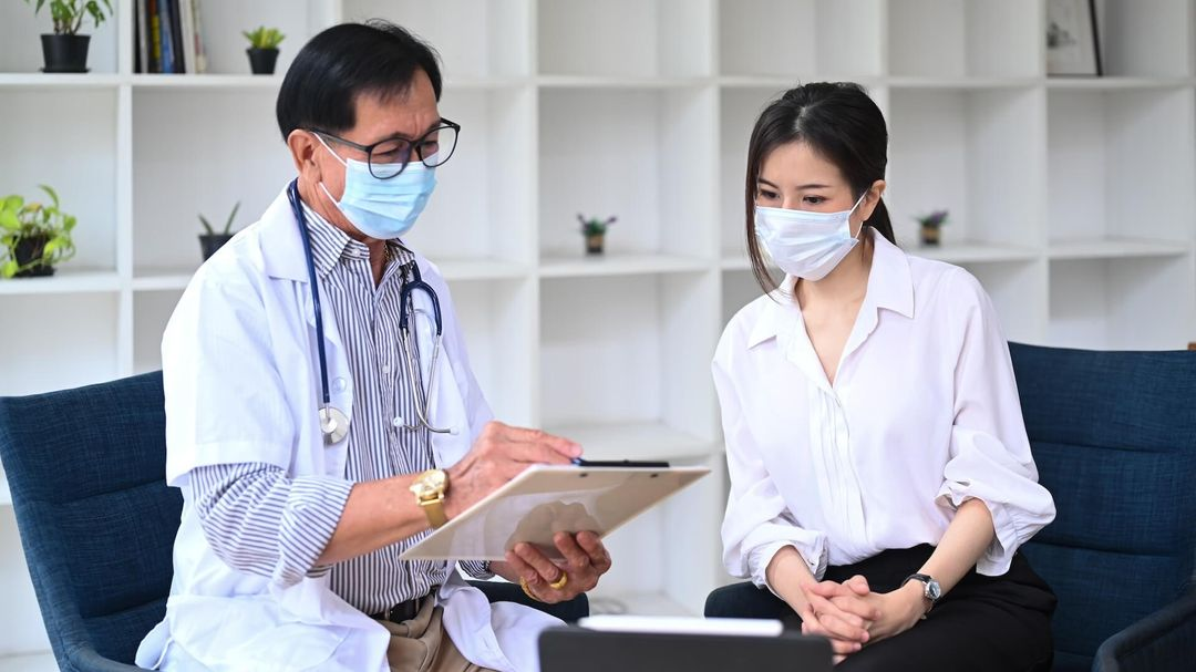 A healthcare provider talking to a patient, emphasizing the importance of patient confidentiality