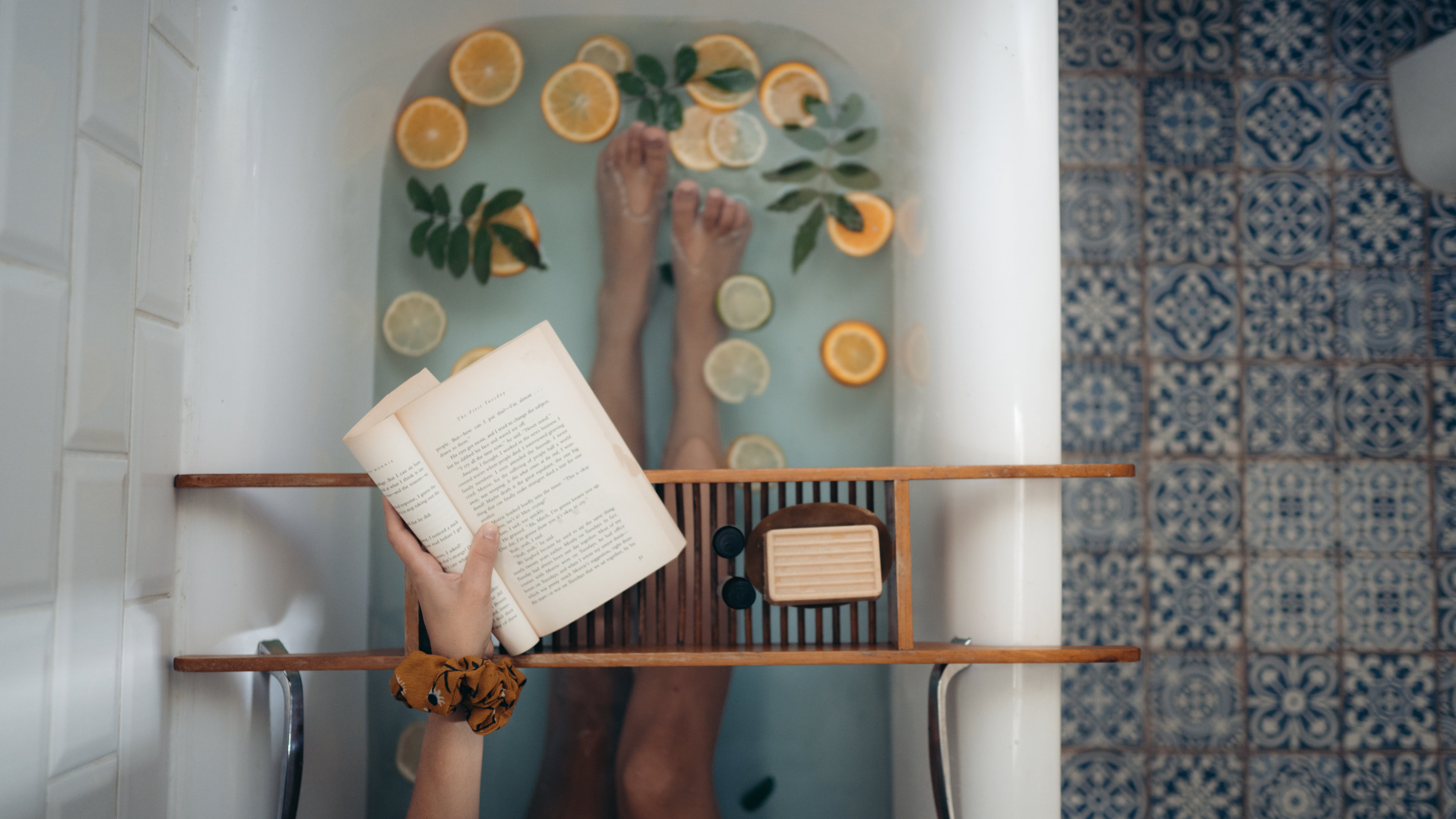 someone reading while taking a soothing bath