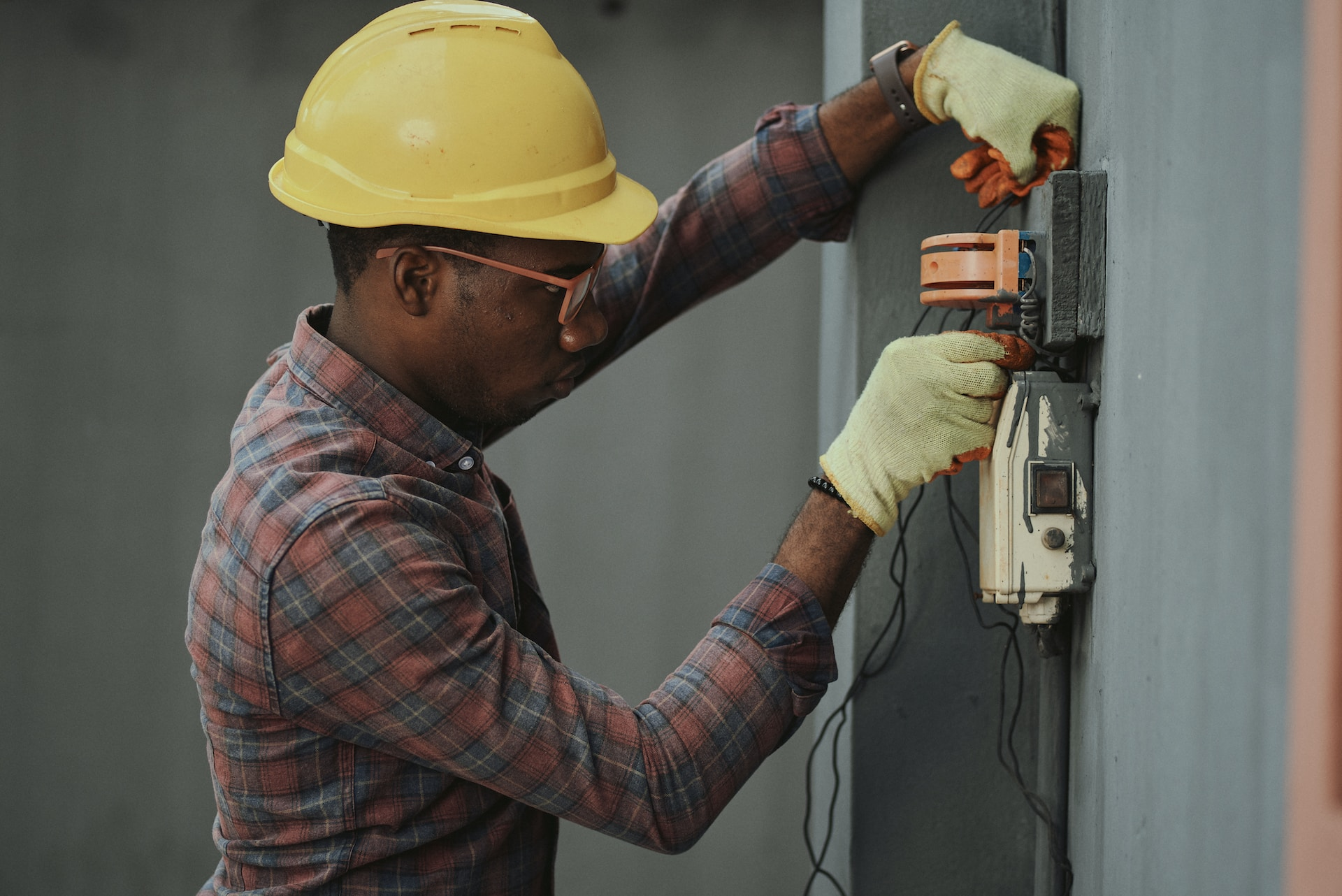A person inspecting a whole house surge protector