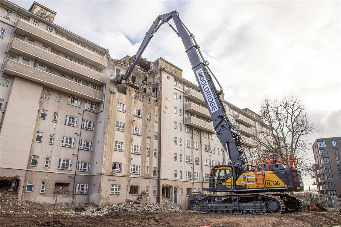 image is showing high reach demolition excavator working on site.