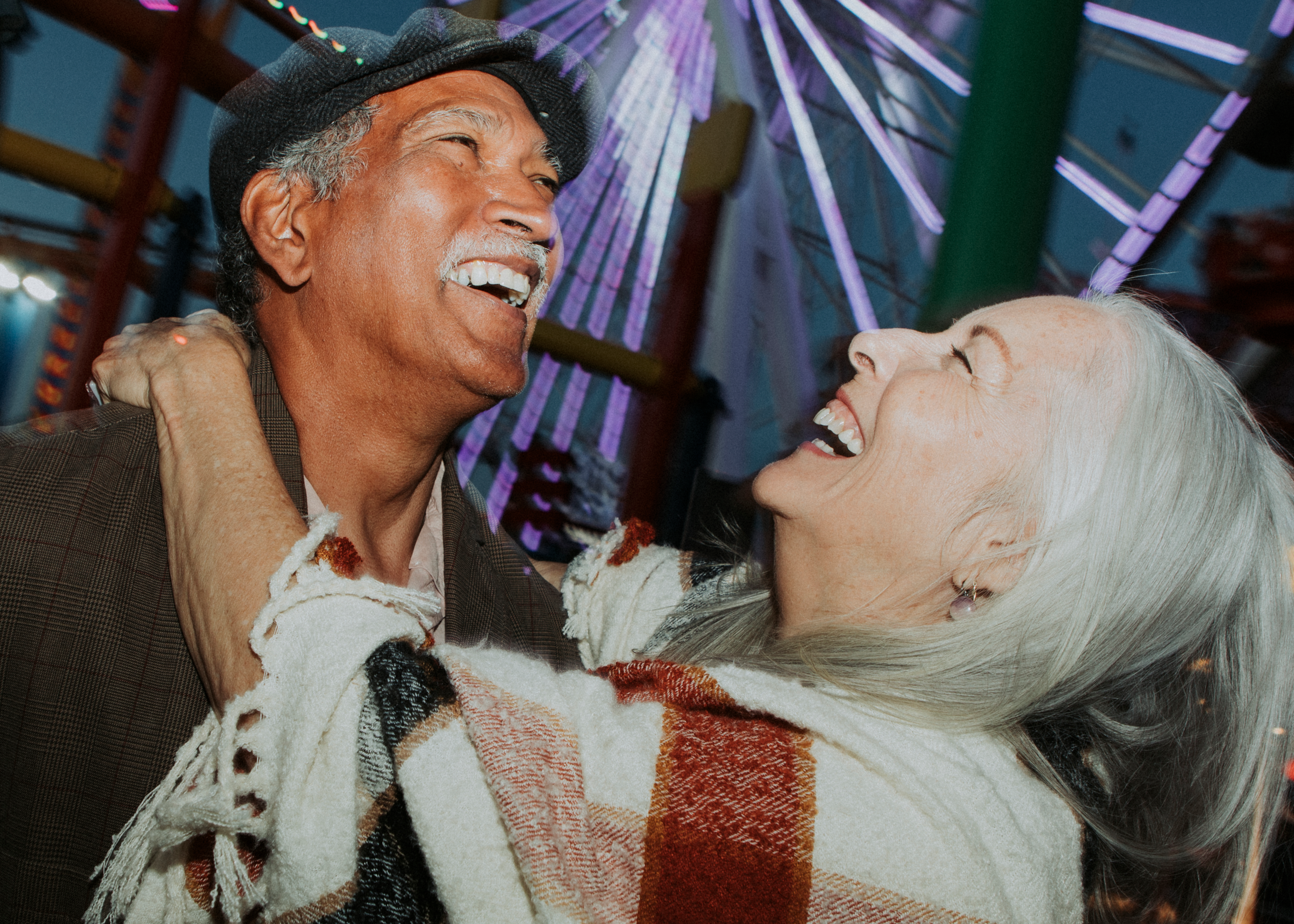At Pacific Park in Santa Monica, a cheerful elderly couple embodies the spirit of common law marriage; their enduring love testament to the deep bonds formed through years of unwavering partnership, showcasing that true commitment goes beyond legal certificates in the golden state of California.