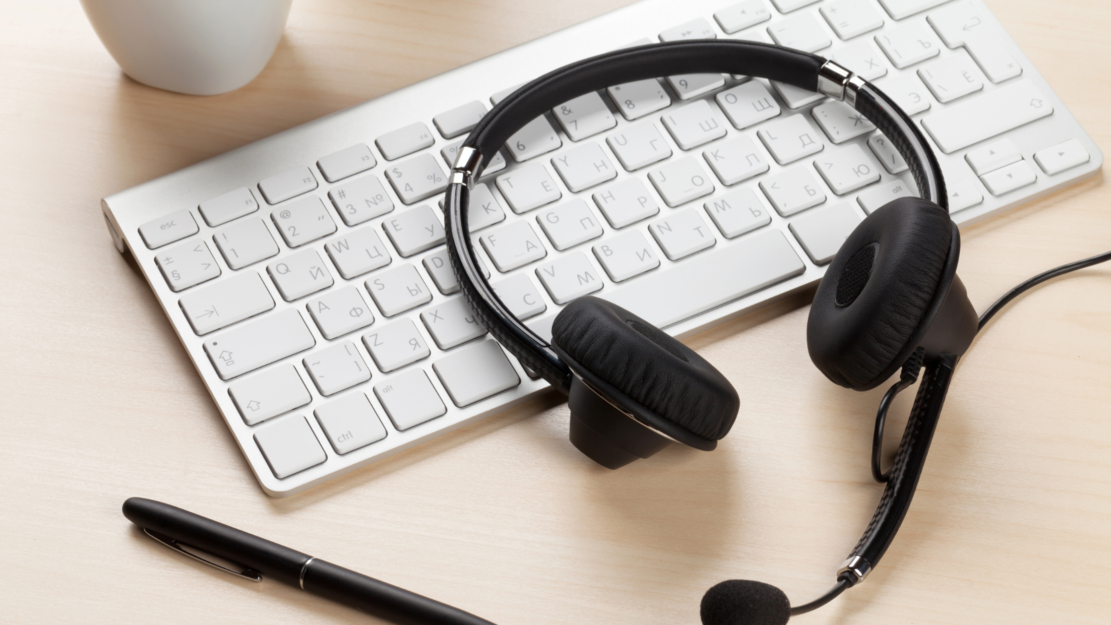 Headset resting on a keyboard, symbolizing dedicated customer support, enhanced service, and post-deployment assistance for remote access.