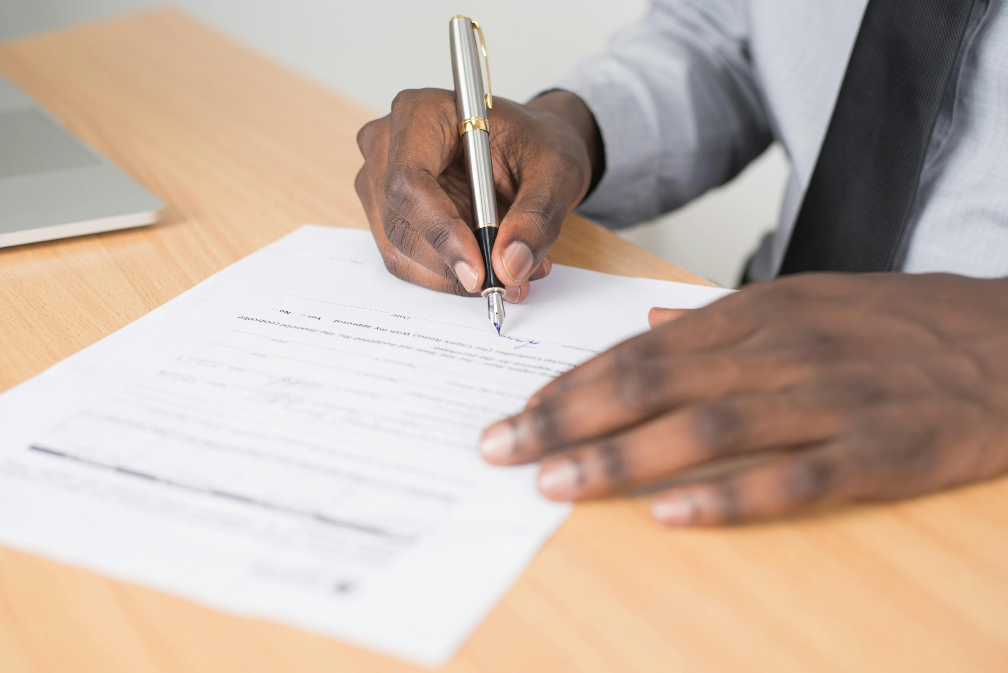 Real estate wholesaler signs contact, securing deal on a property.