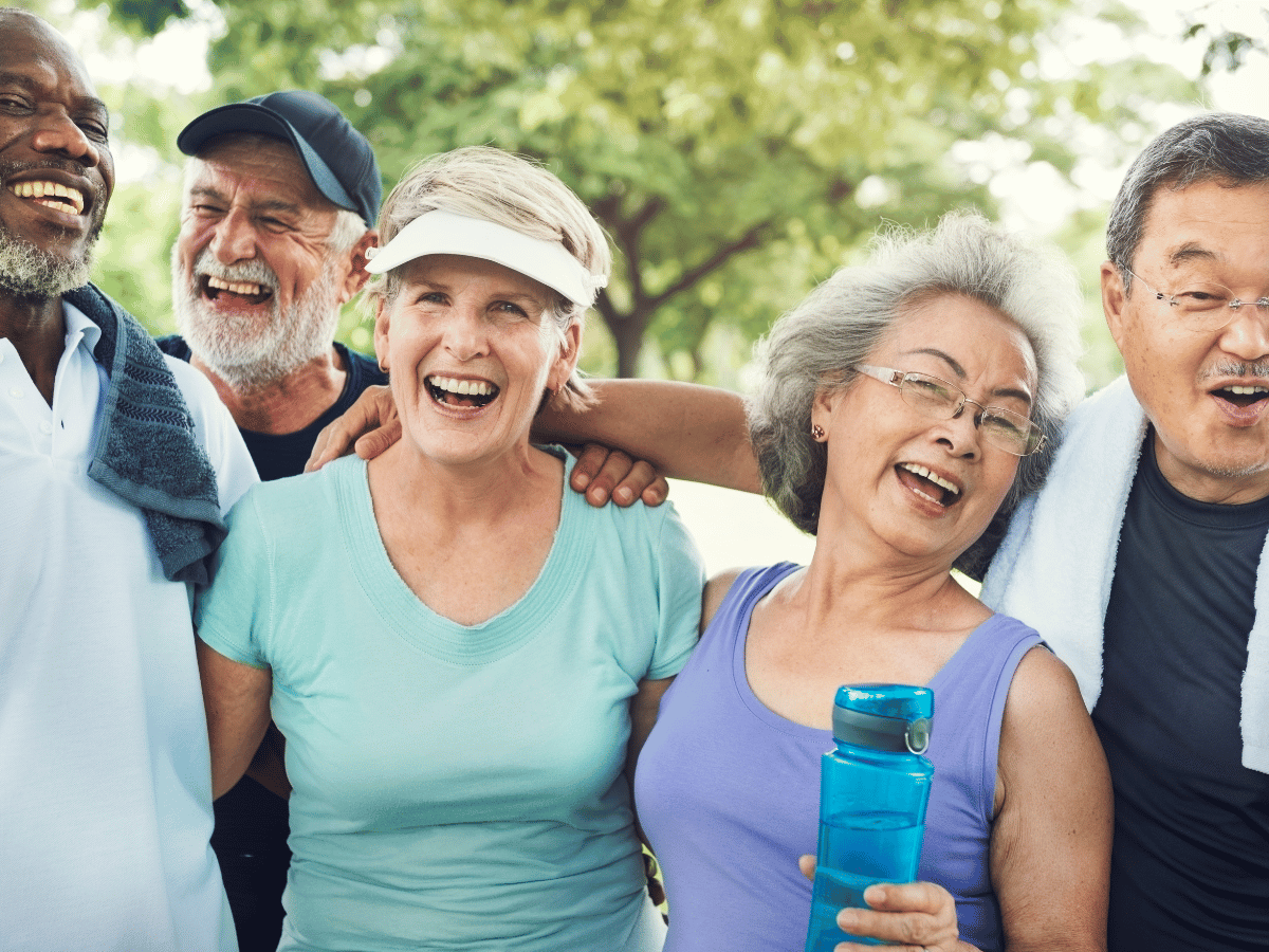 group of smiling seniors with various dental procedures completed for missing teeth