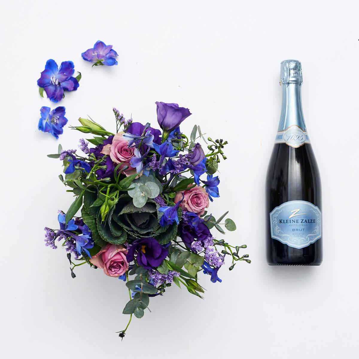 pink, blue and lilac flowers with champagne