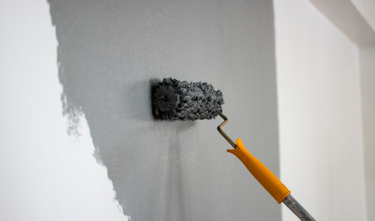 A close-up image of a drywall surface with a coat of paint applied, demonstrating that paint and drywall can you paint drywall without mudding.