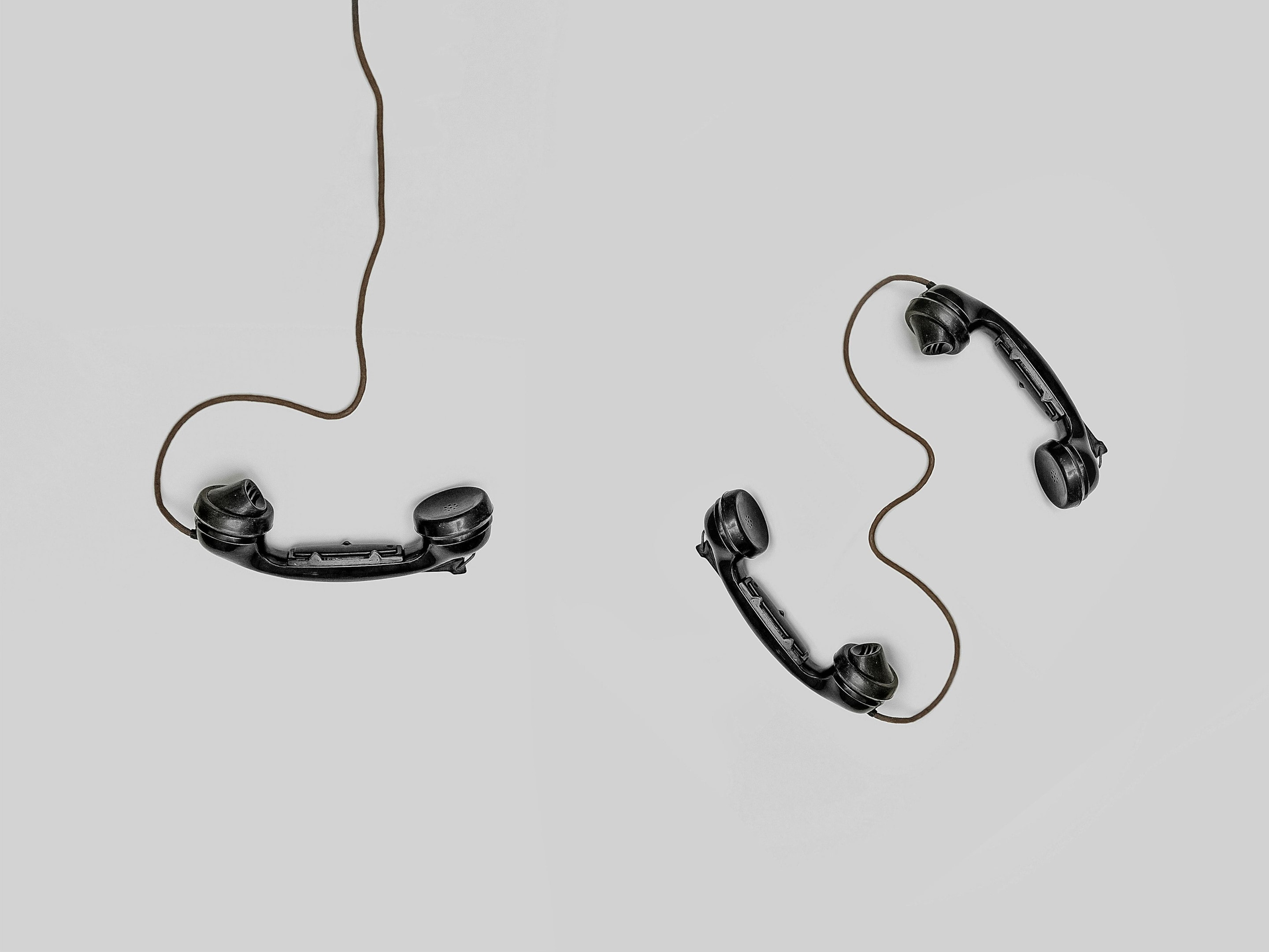 3 phones attached to cords, to be used by real estate professionals.