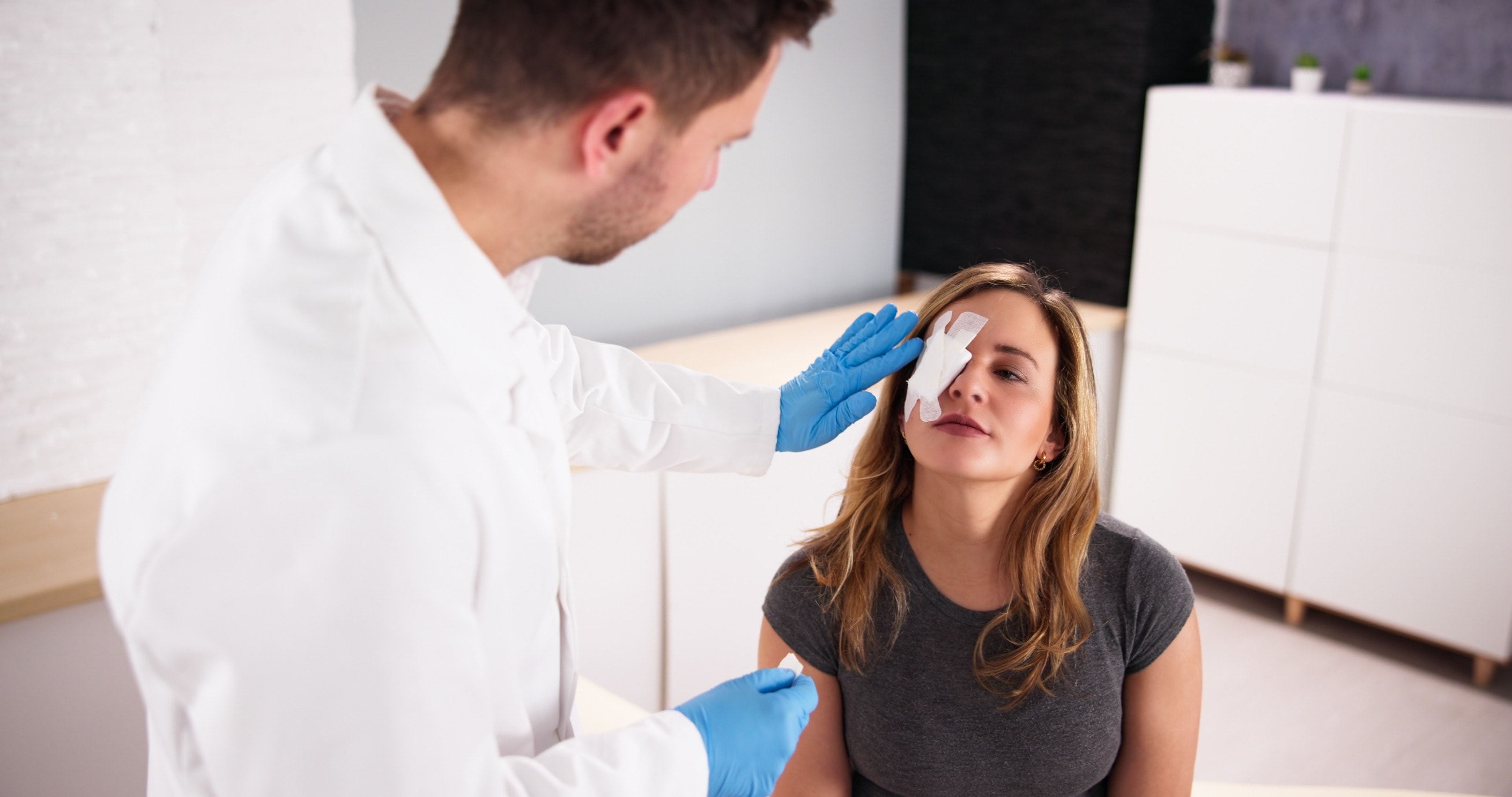 A doctor treating a patient with an eye injury