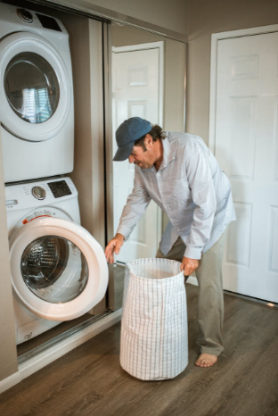 man doing laundry in house