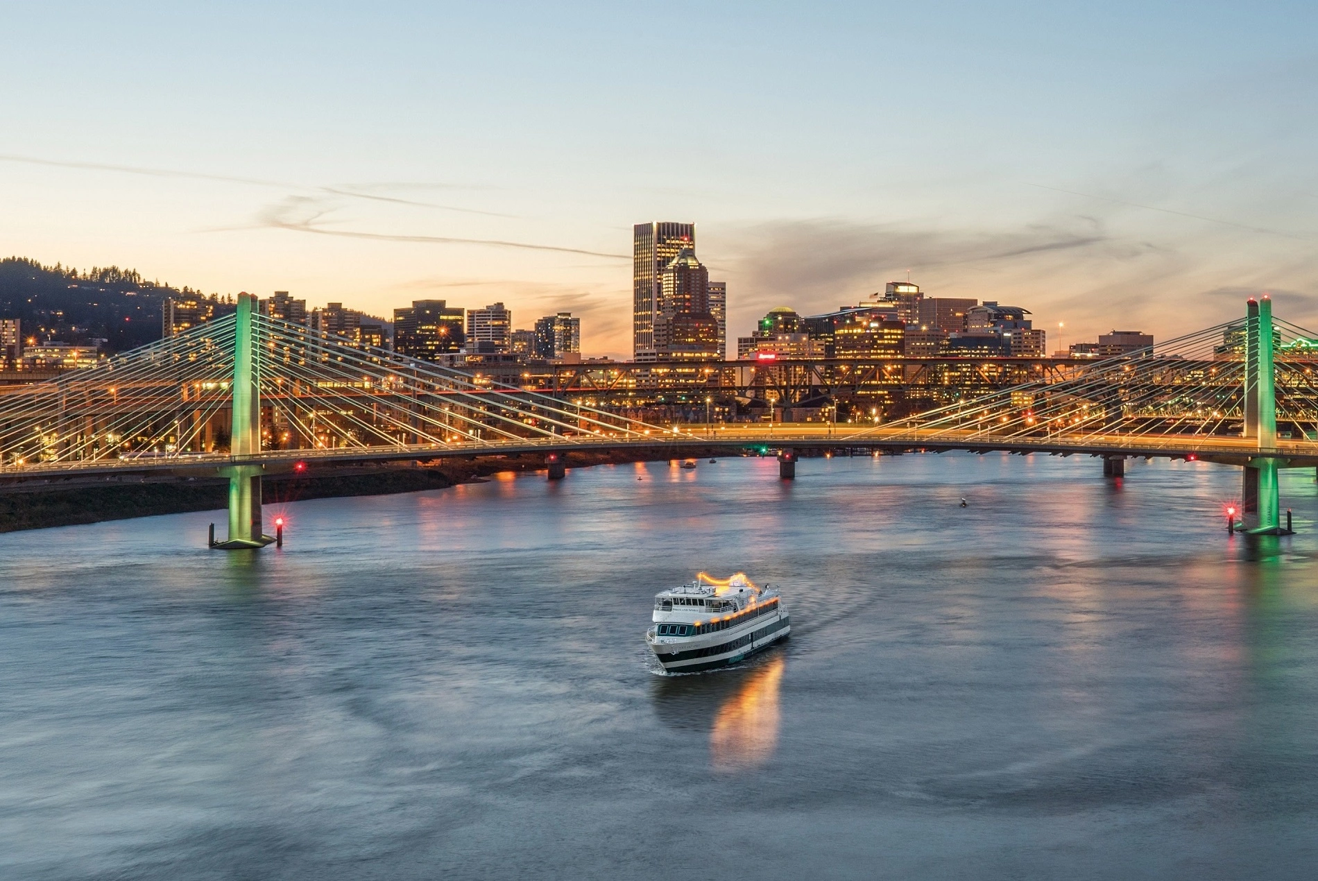 Date idea: a dinner cruise on the Willamette River with the portland cityscrape and bridge in the background 