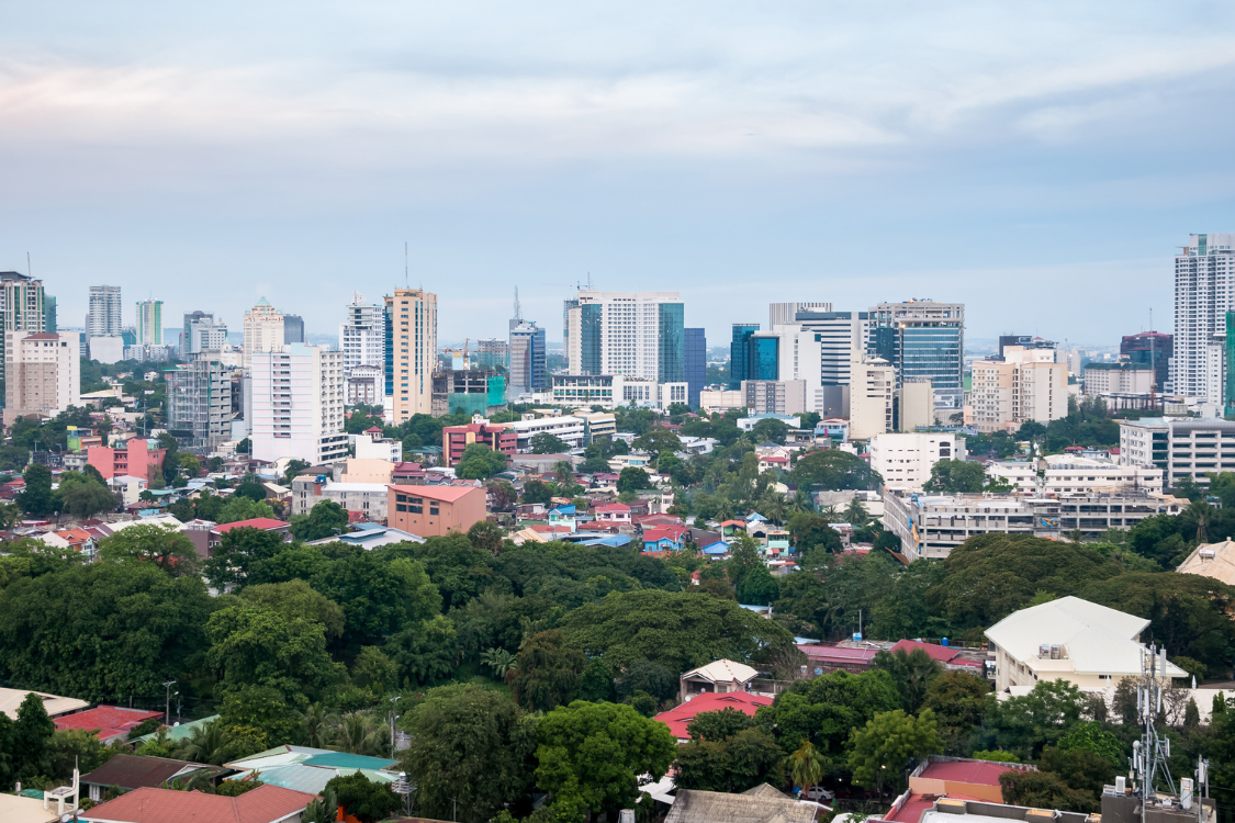 Aerial view of Cebu City showing business parks, residential areas, and commercial buildings under blue skies.