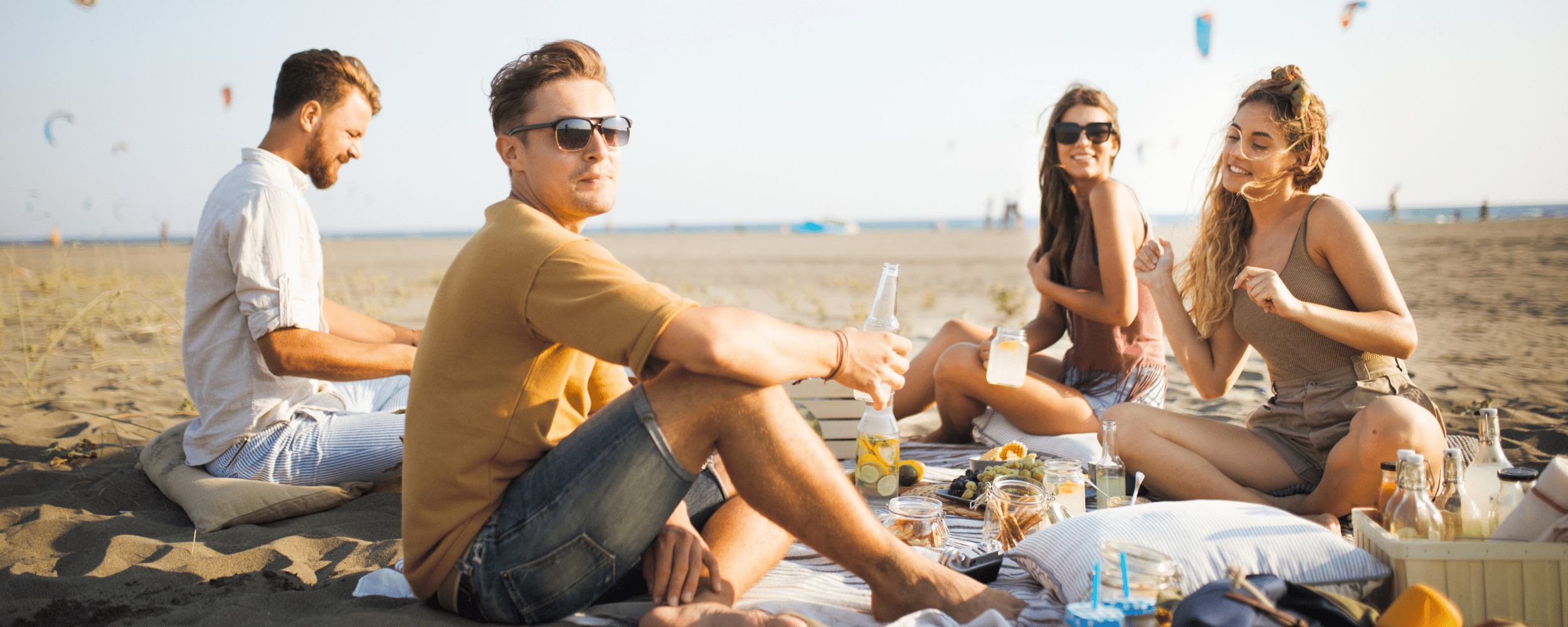 young men and women picnicking by the beach