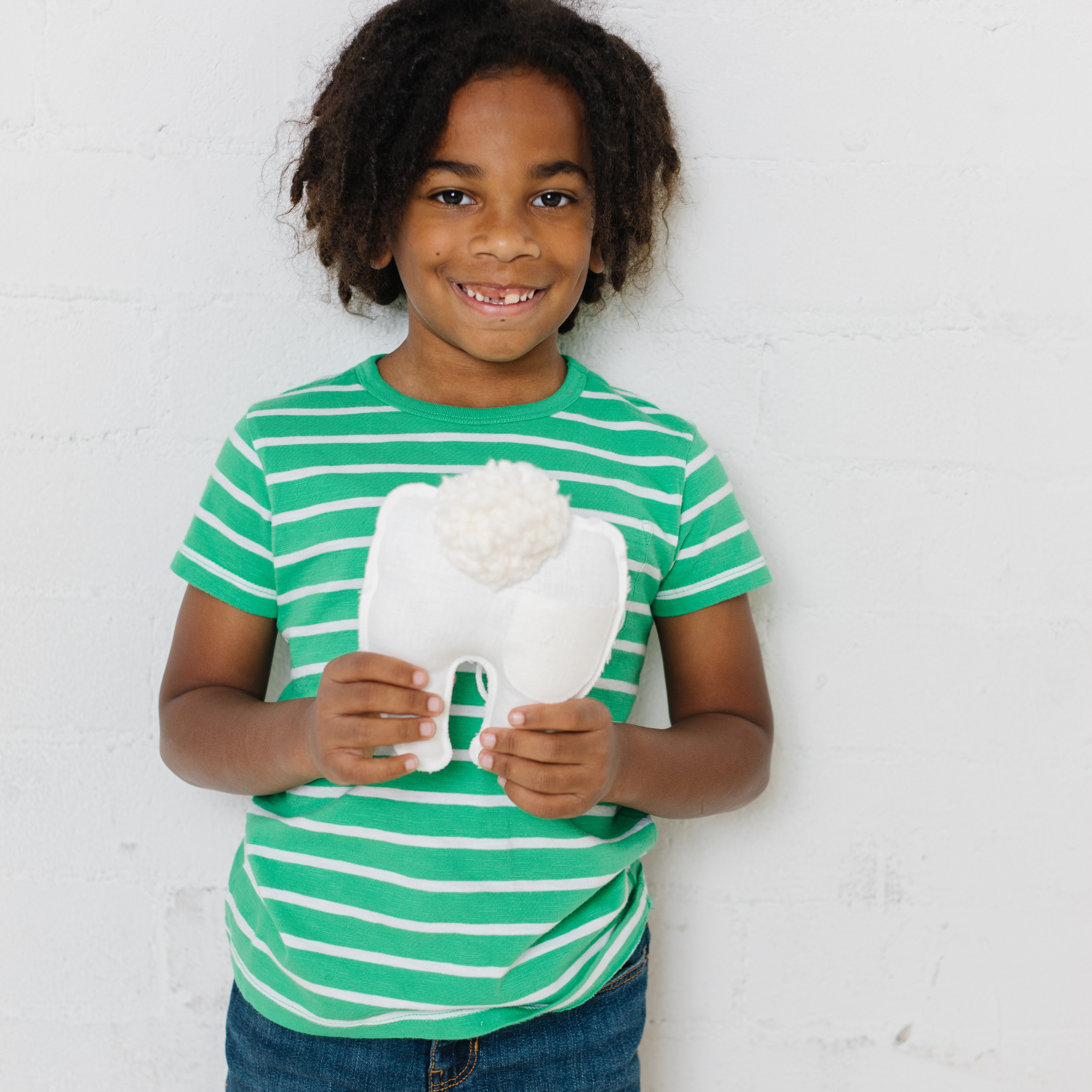 A child with a tooth fairy pillow.