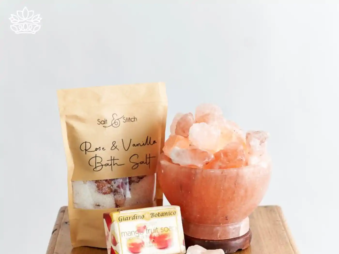 Elegant wellness setup featuring Rose & Vanilla bath salt and a bowl of Himalayan pink salt crystals alongside mango fruit soap. Fabulous Flowers and Gifts - Housewarming. Delivered with Heart