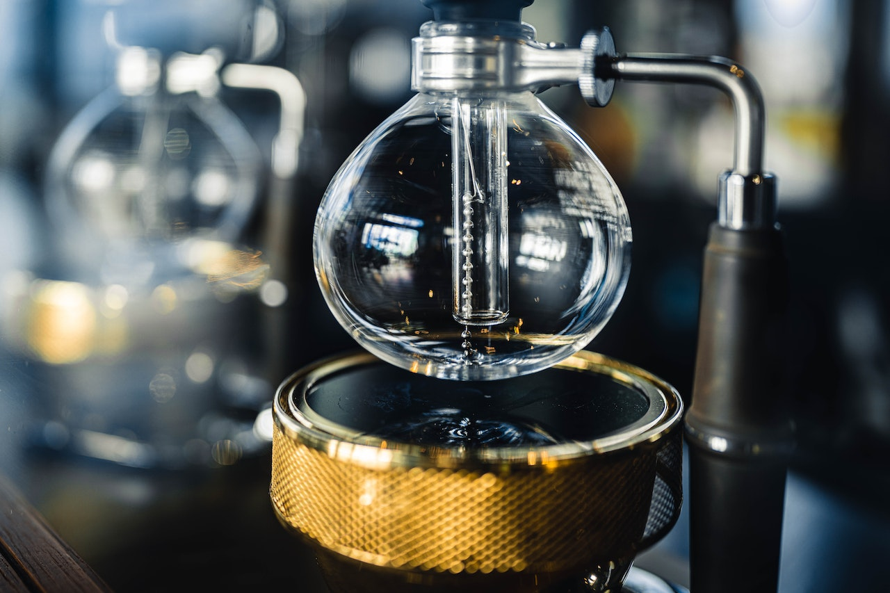 A modern syphon coffee maker on a counter