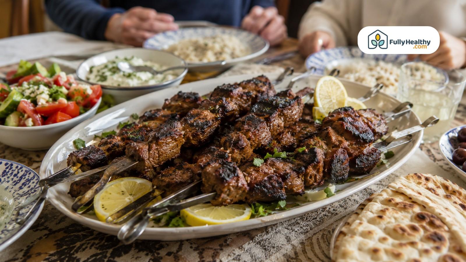 Grilled lamb skewers with lemon, flatbread, rice, salad, and creamy dip