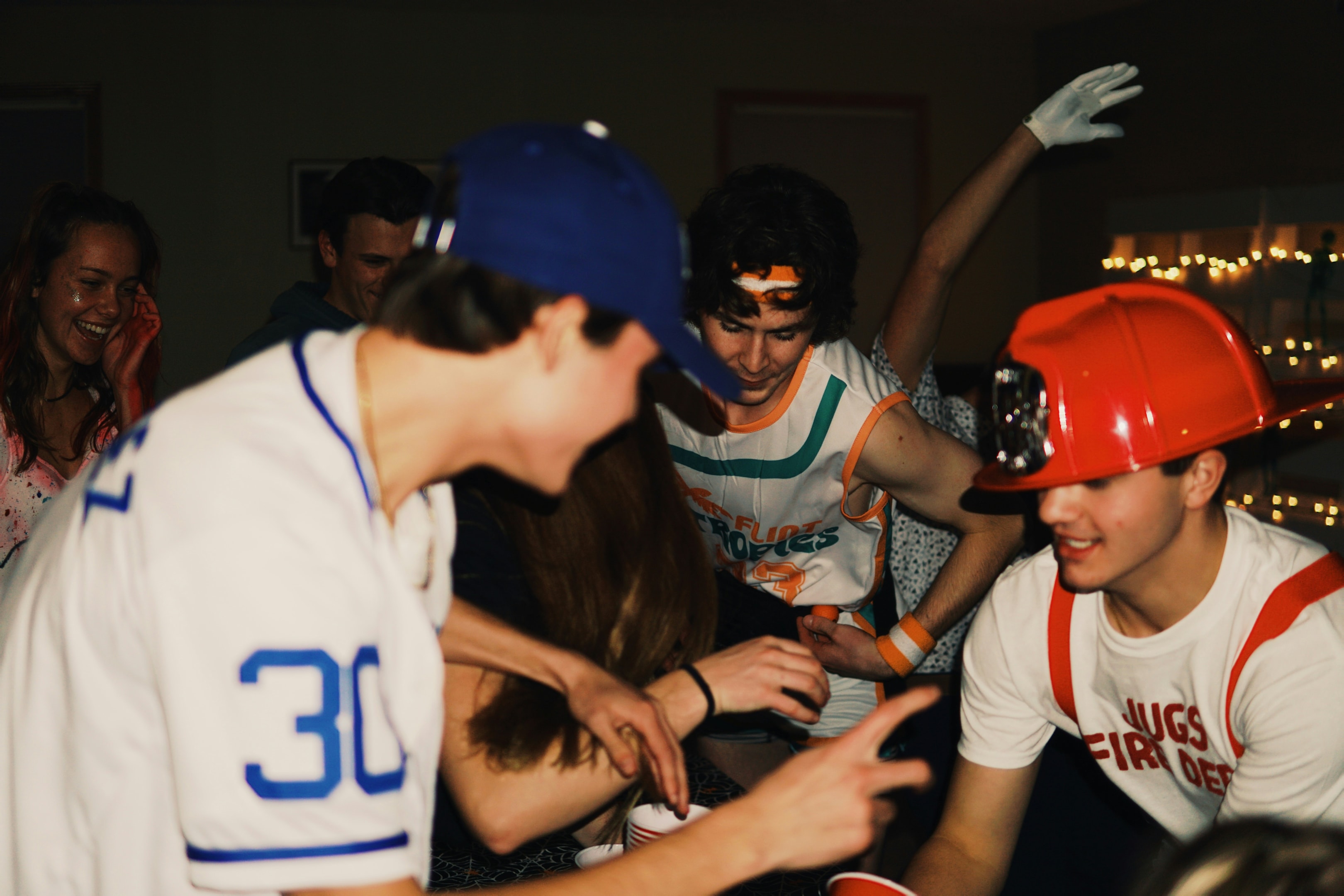 guys with cap and helmet playing a game or dancing