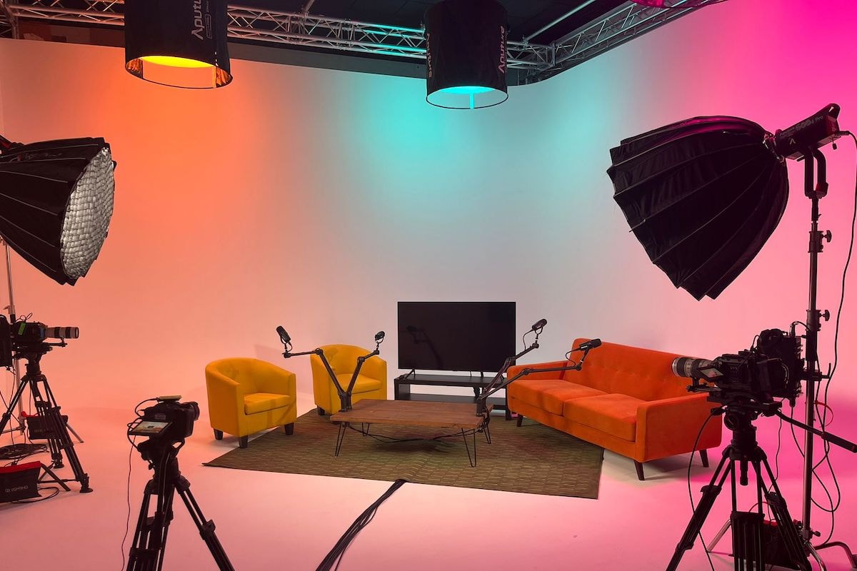 Colorful podcast studio with professional lighting and equipment