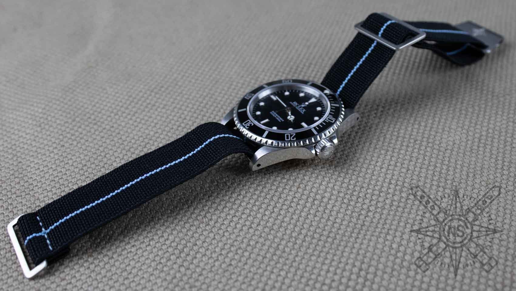 Key features of marine nationale straps including elastic webbing and stainless steel clasp.