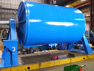 A ball mill used in the ore processing industry for grinding and blending materials.