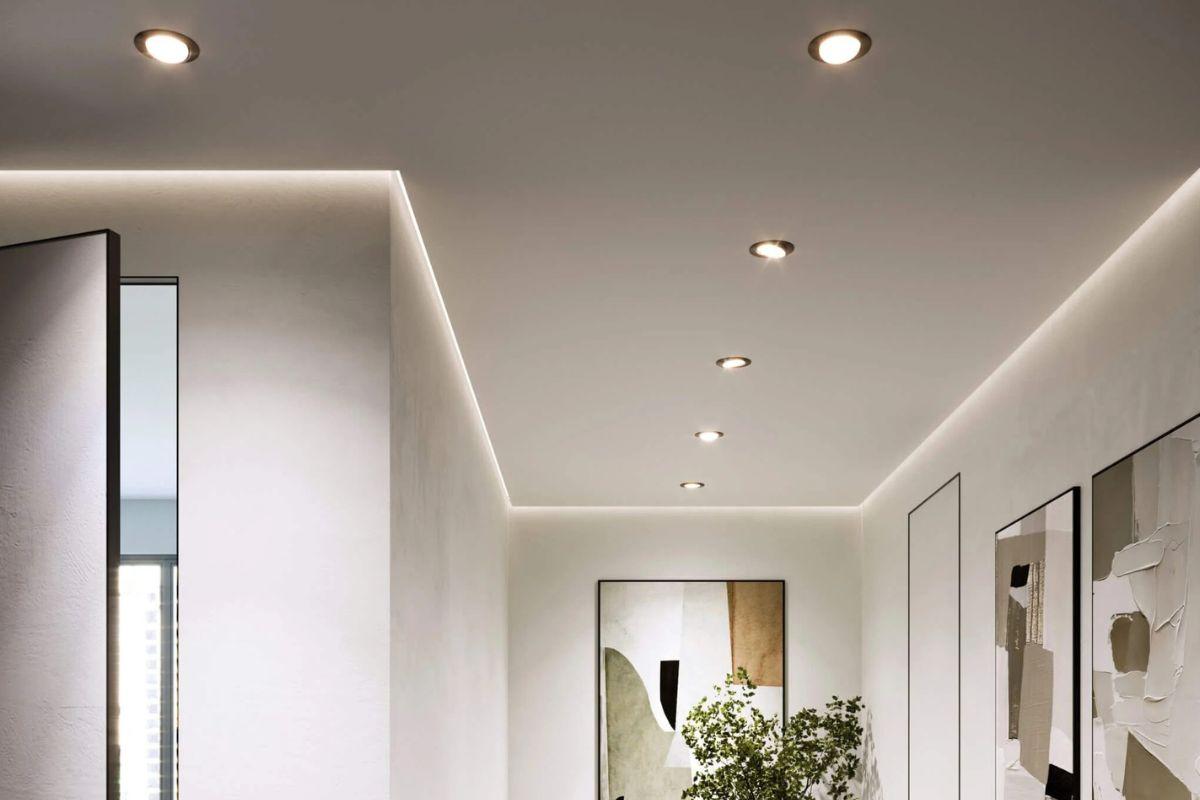 Modern hallway with recessed downlights and indirect accent lighting along the ceiling edges