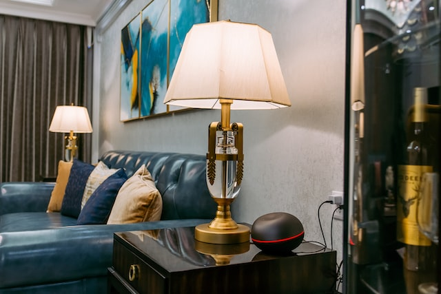 teal leather sofa with throw pillows and two side tables with lamps - image credit: https://unsplash.com/photos/Dr2klA3gVpE
