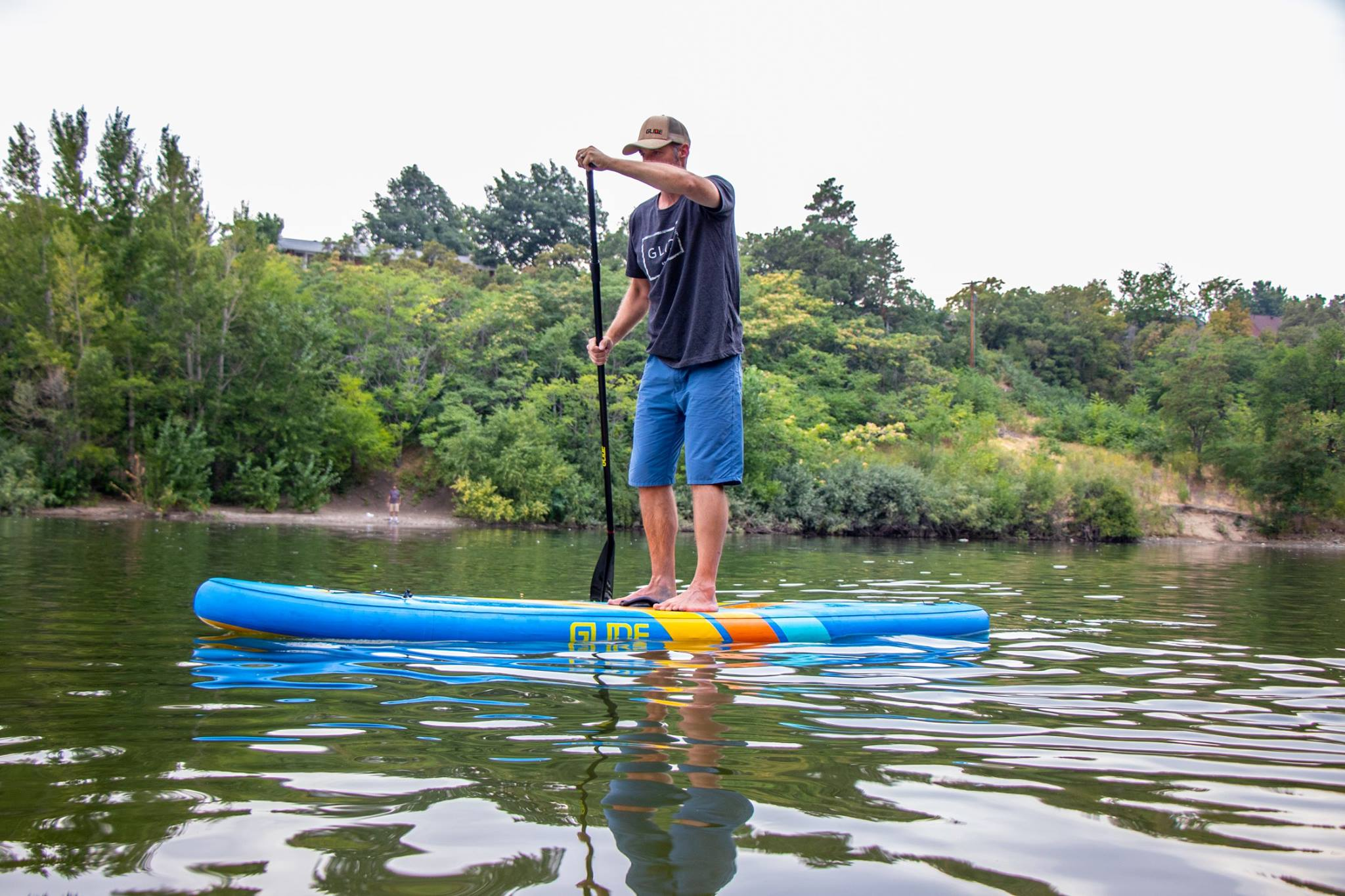 man on an inflatable stand up paddle board