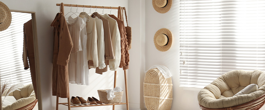 An Artiss bamboo garment rack with shelves, used for bedroom clothes storage.