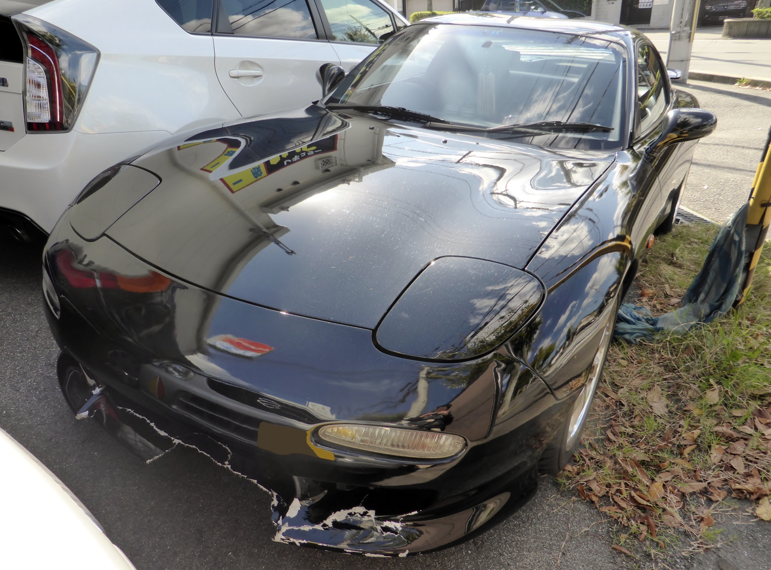 A person inspecting a car with a salvage title, looking for signs of damage and assessing the vehicle's condition