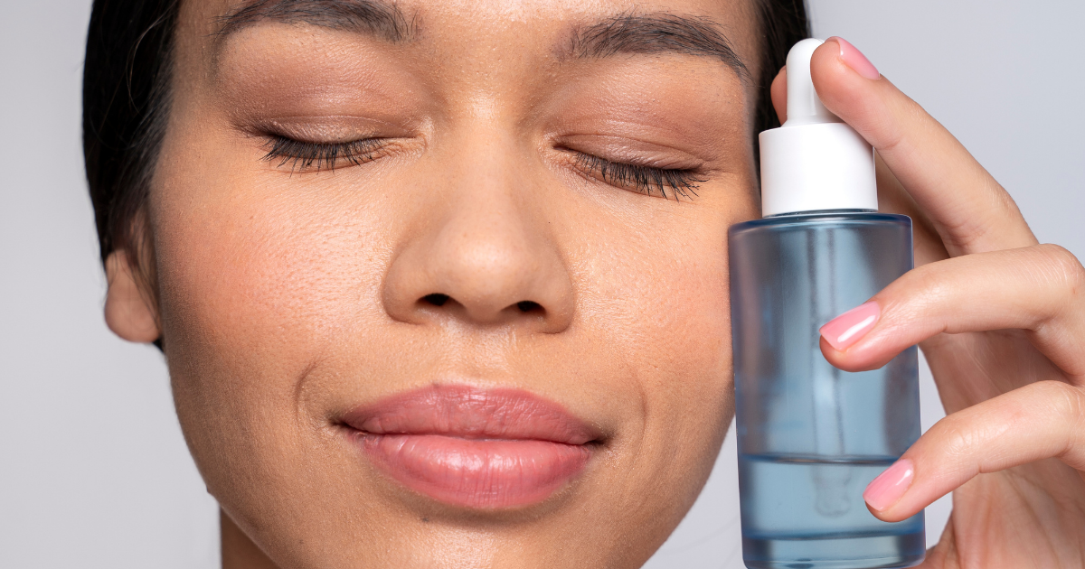 Close-up of a woman with a calm expression holding a blue serum dropper bottle, representing soothing relief for irritated and sensitive skin.