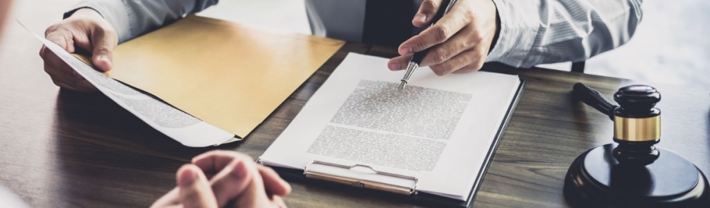 A bankruptcy attorney reviews client paperwork to determine eligibility.