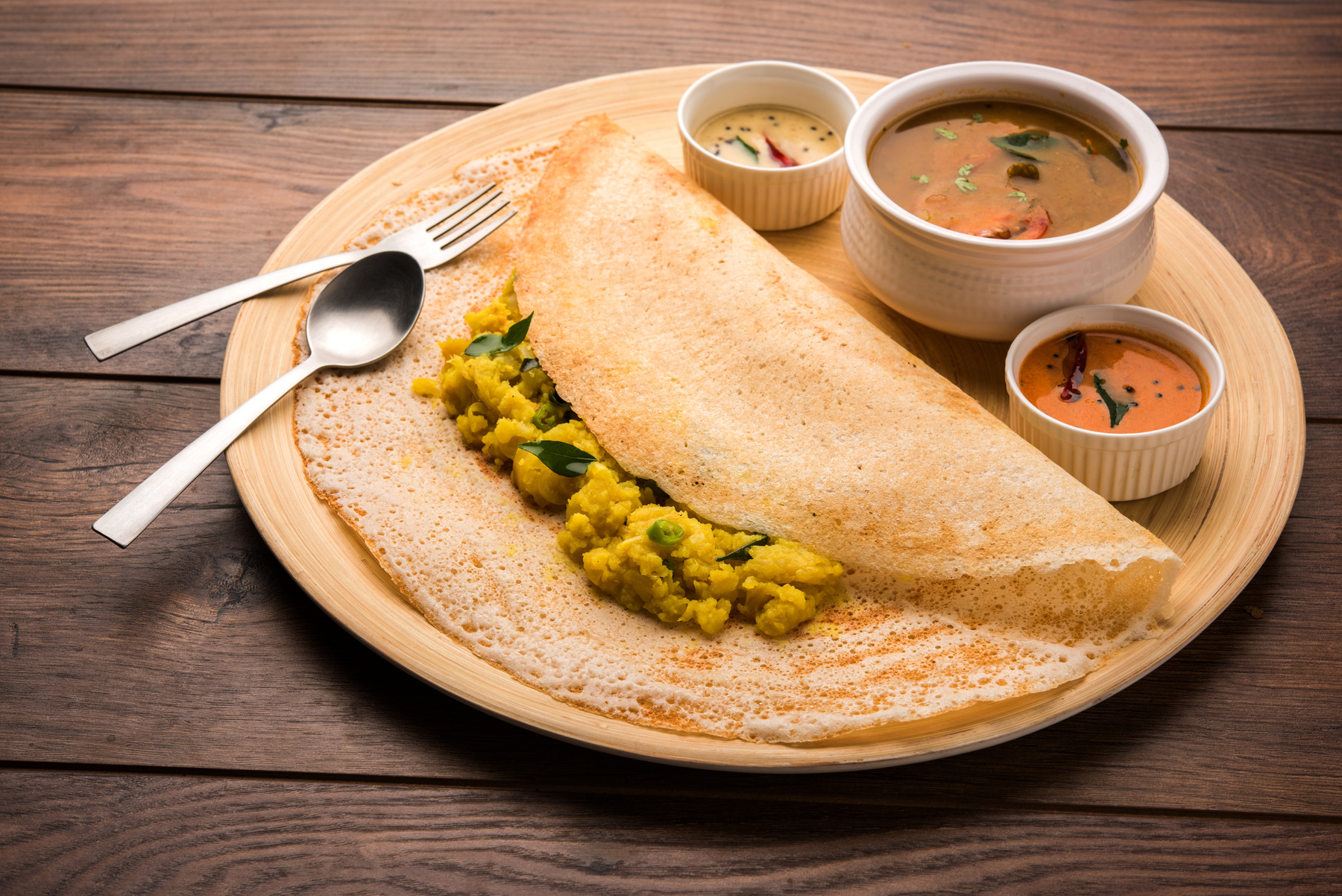 Dosa with coconut chutney and sambhar, a South Indian culinary delight