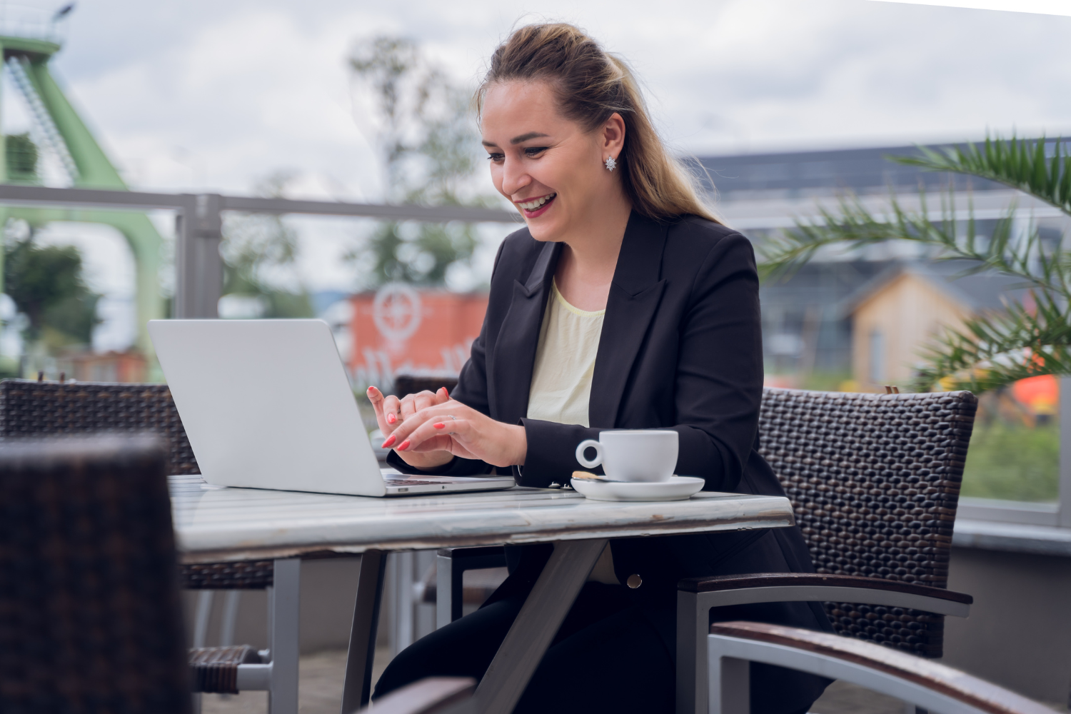 Manager smiling at laptop.
