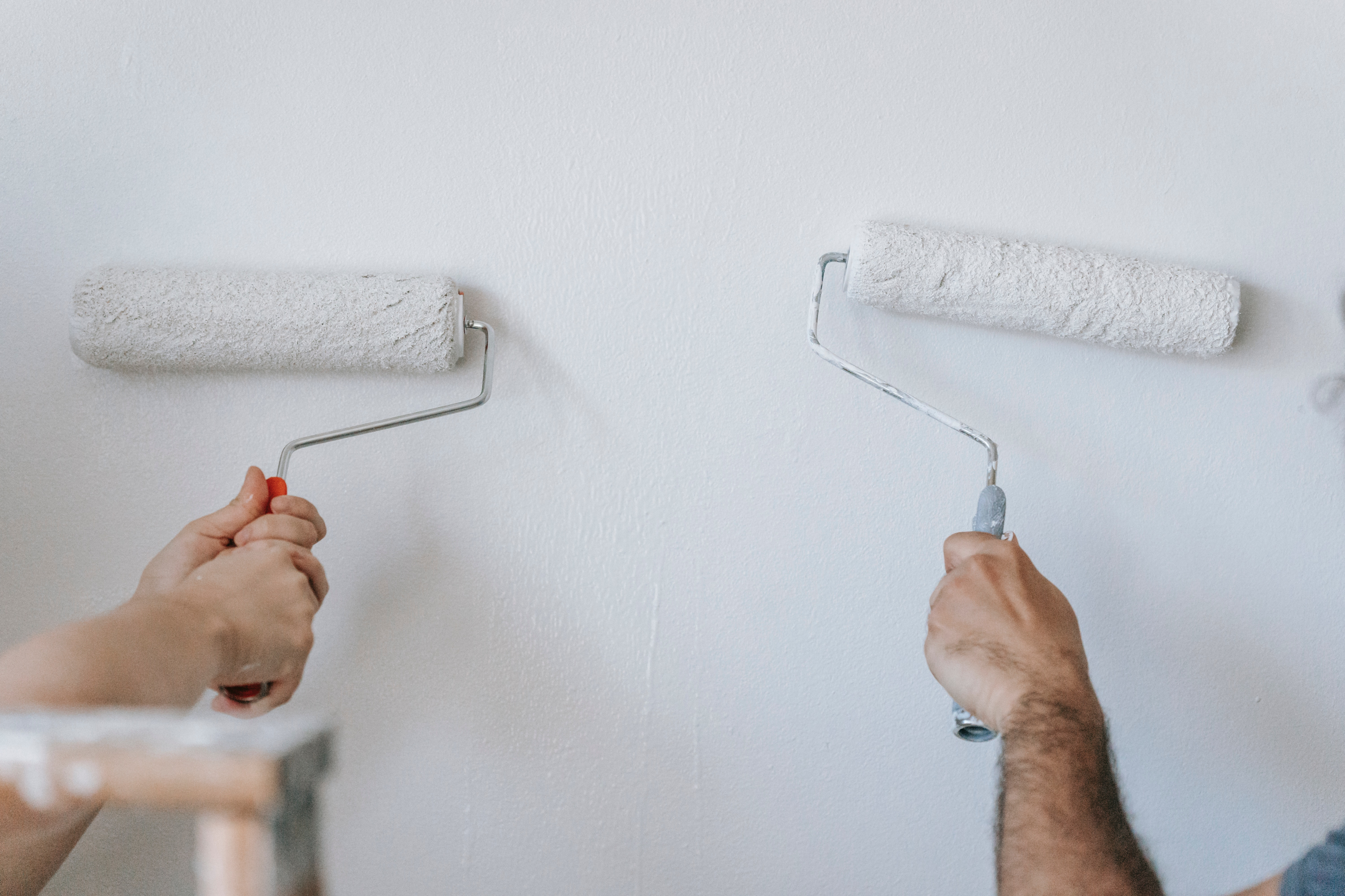 Tenants adding touch up paint after removing soft adhesive vinyl stickers from the wall