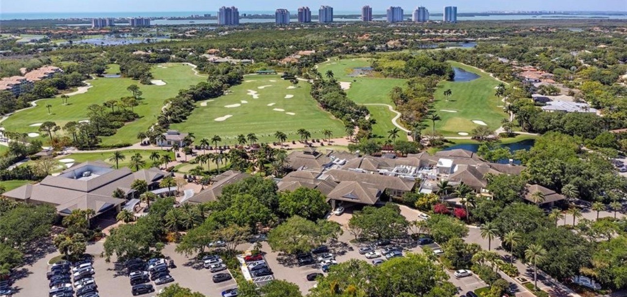 The image depicts the championship golf course at Bonita Bay in Bonita Springs, featuring lush, pristine fairways complemented by serene water features. This picturesque setting is part of the Bonita Bay Club, known for its exceptional amenities and beautiful landscapes, making it a haven for golf enthusiasts.