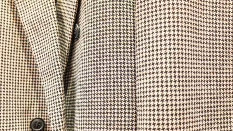 A close-up of a woven suit with a houndstooth pattern