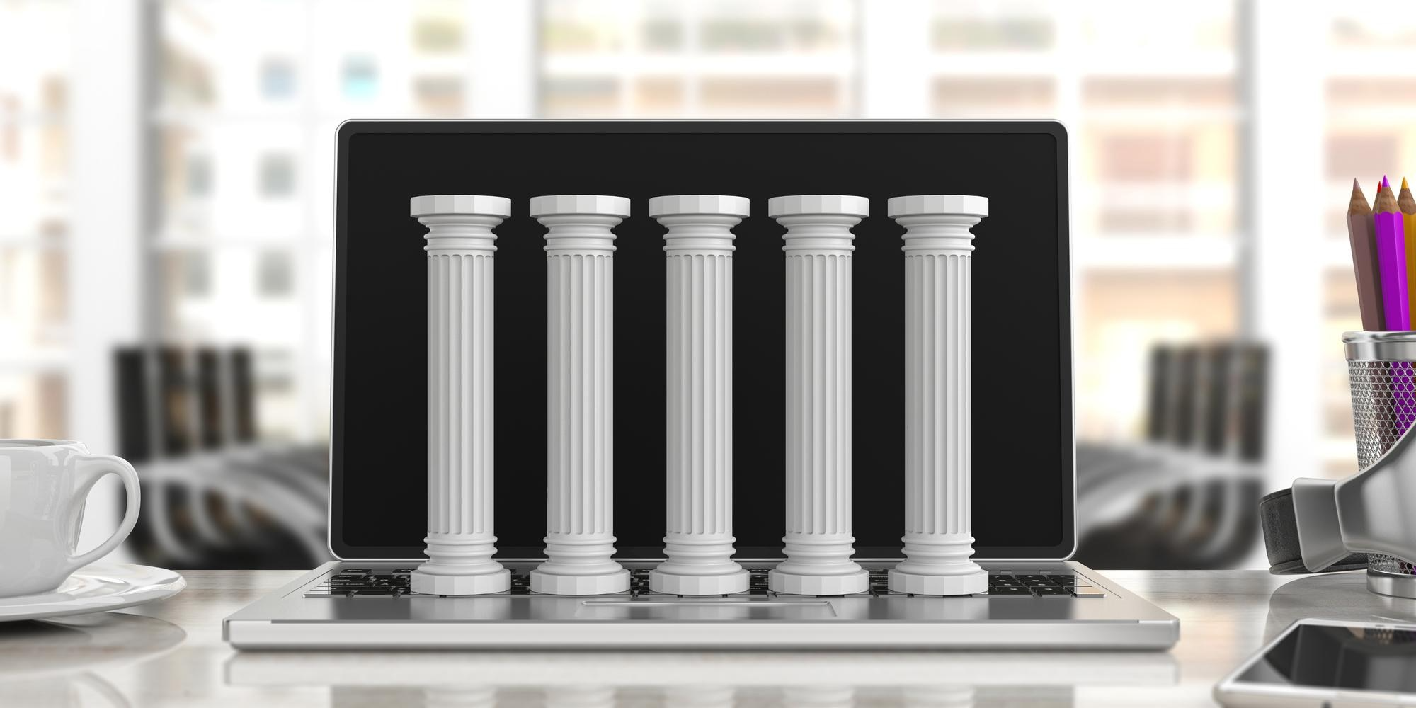 Five stone pillars inside a laptop, symbolizing the five key pillars in a telecom lifecycle management strategy and execution.