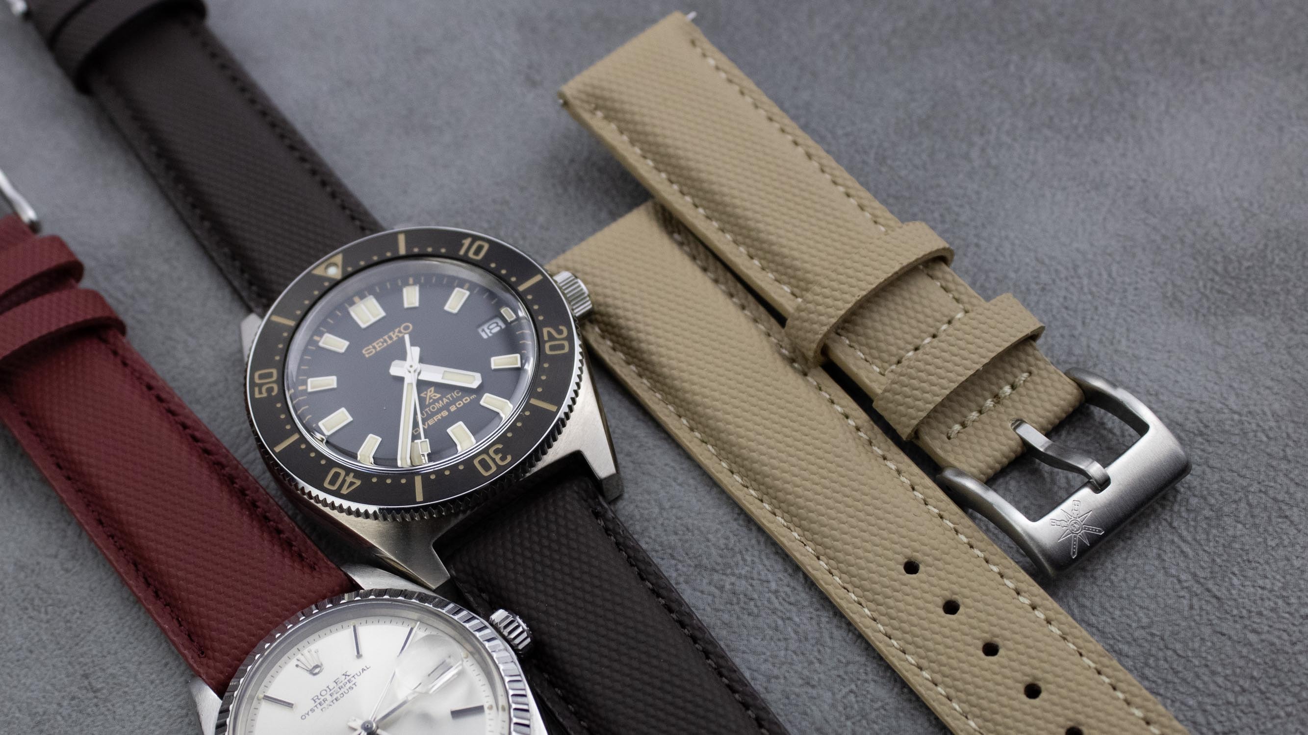 An assortment of watch straps including leather and sailcloth materials.