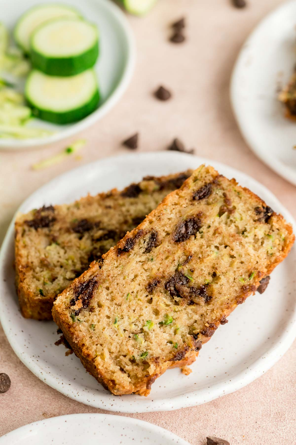 two slices of chocolate chip zucchini bread on a plate
