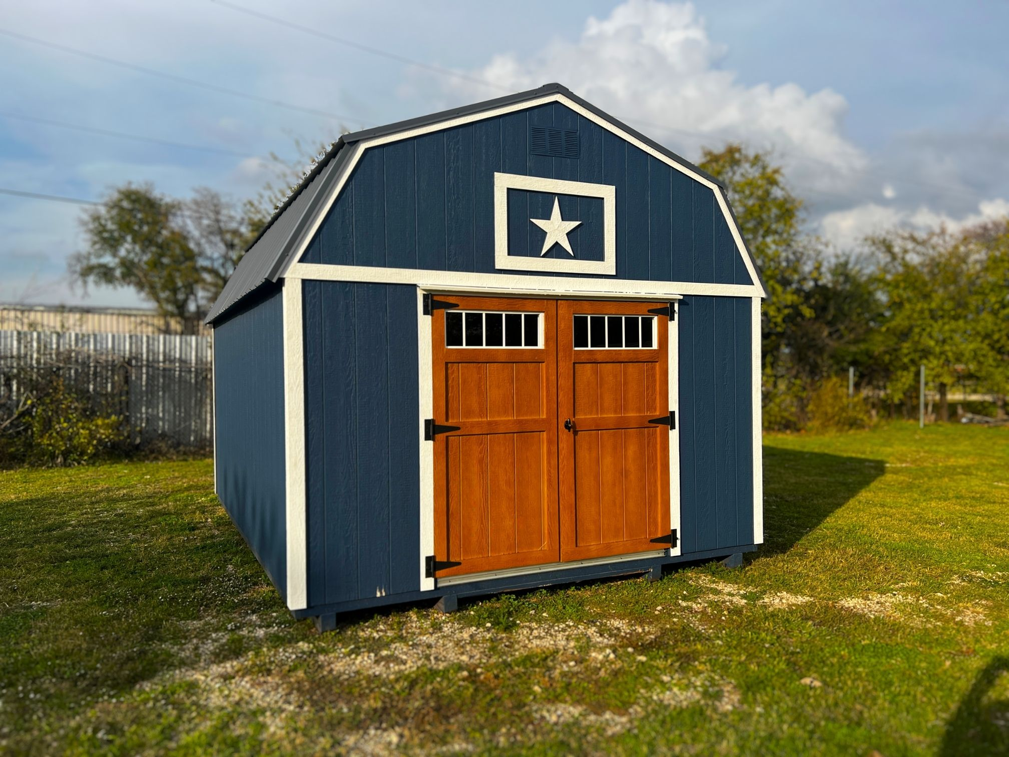 blue lofted barn with wood finished doors