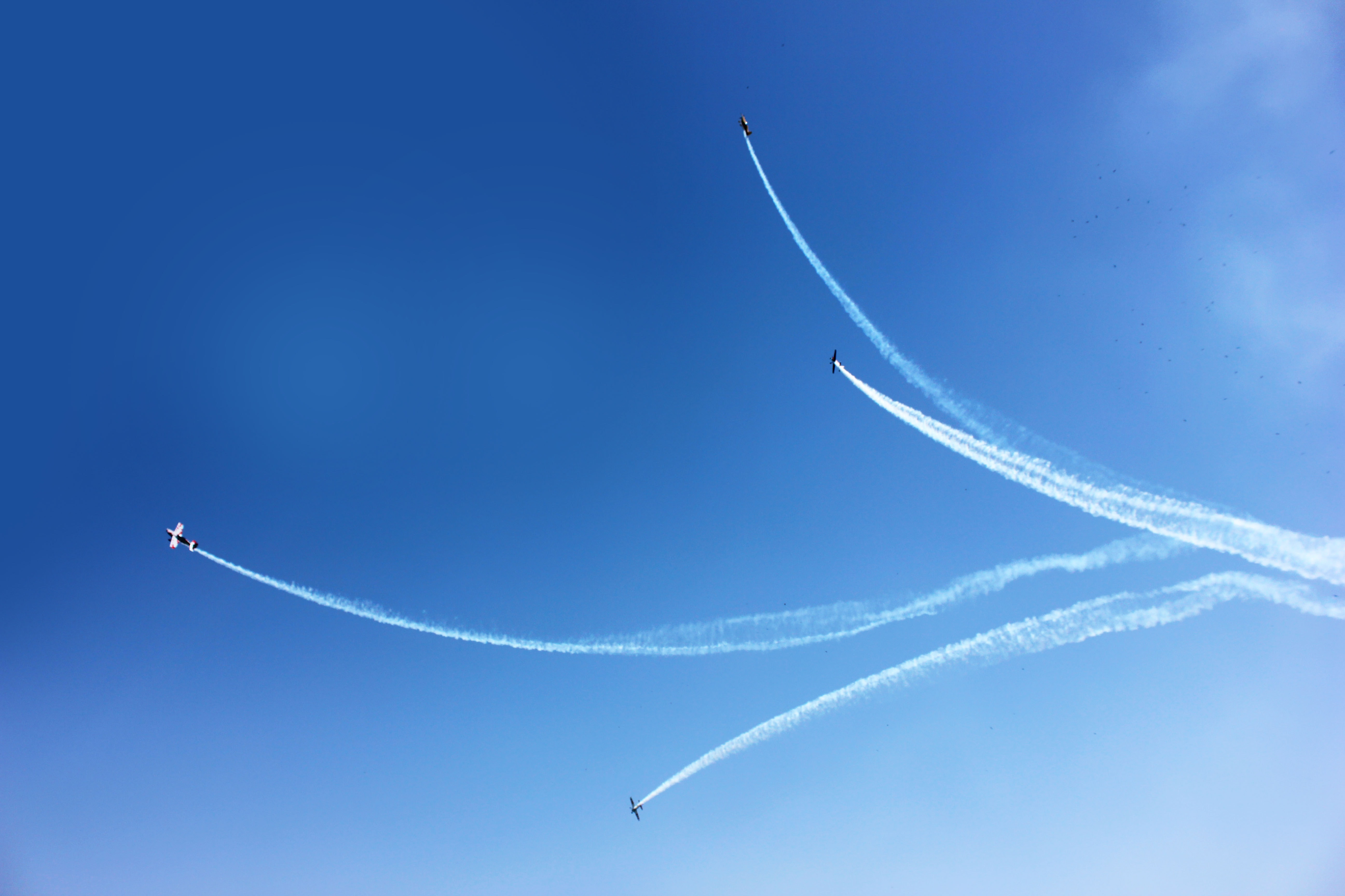 An aerobatic air show with four planes performing an act