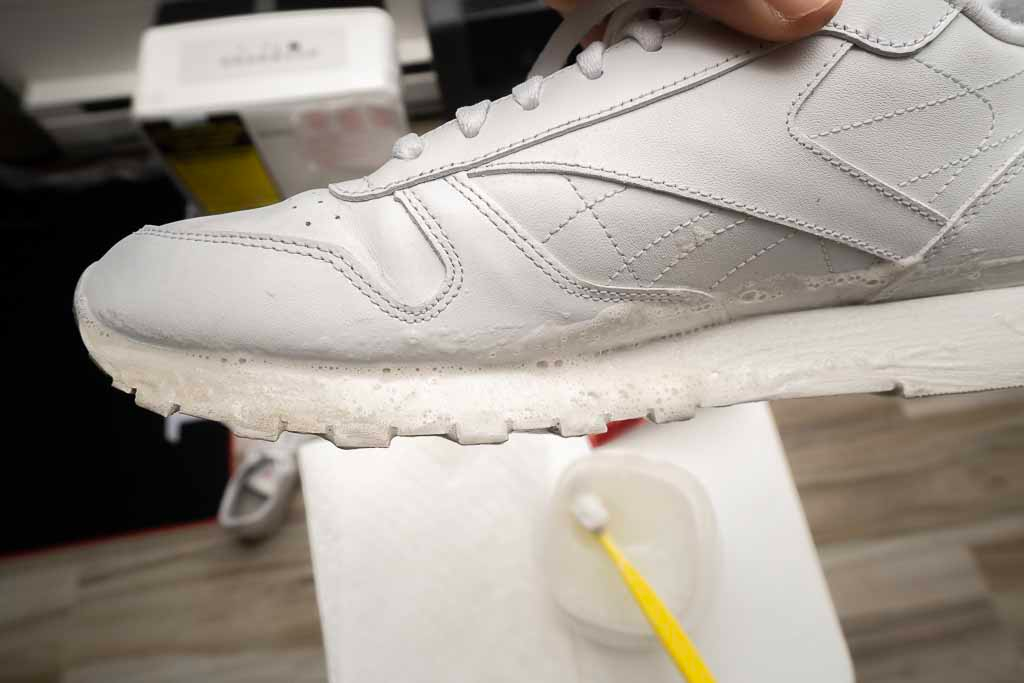 Cleaning white dirty shoes with toothpaste