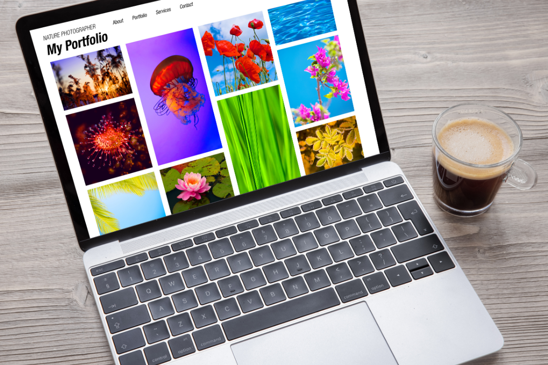 Open laptop displaying a digital portfolio of photography projects with a coffee cup beside it